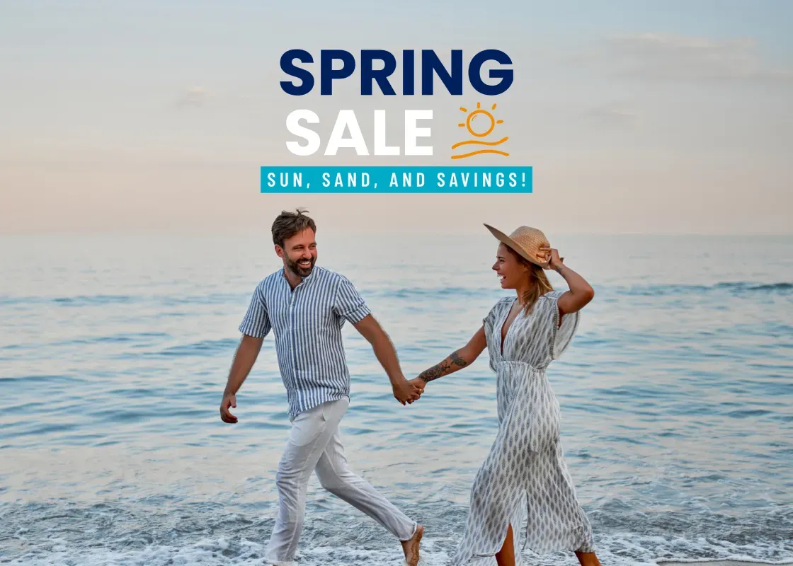 Couple walking along the beach at sunset, promoting the "Spring Sale" for Holy Week and Easter in Cancun.