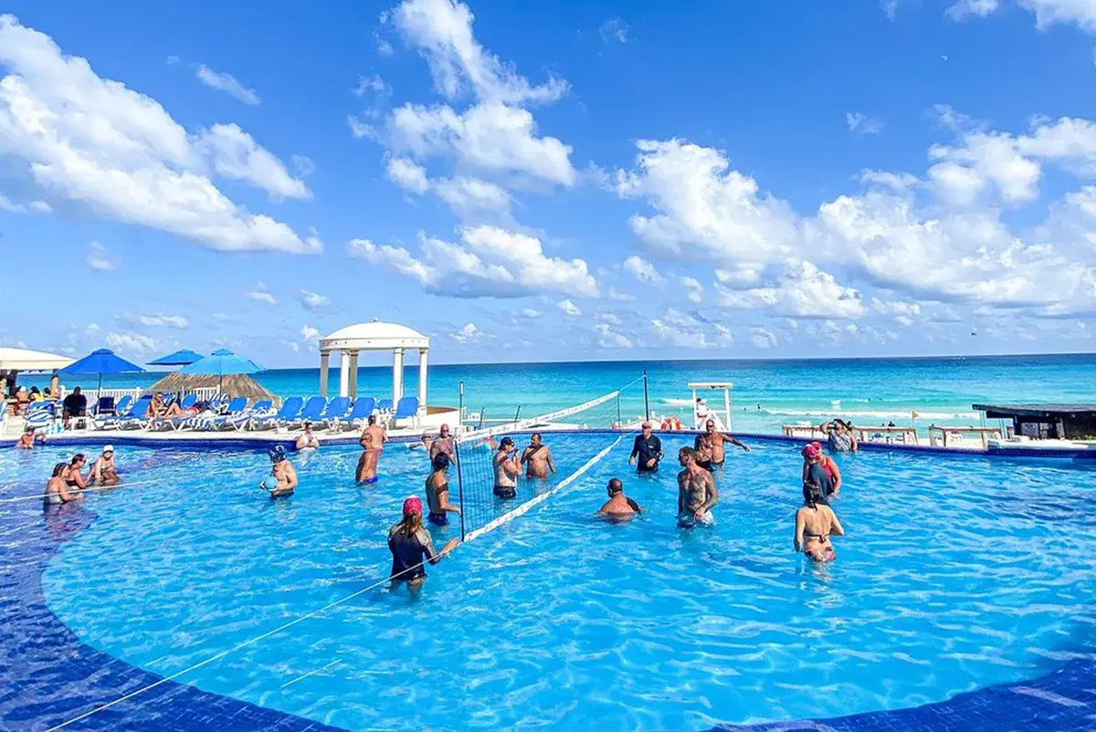 Adults-enjoying-the-pool-playing-volleyball